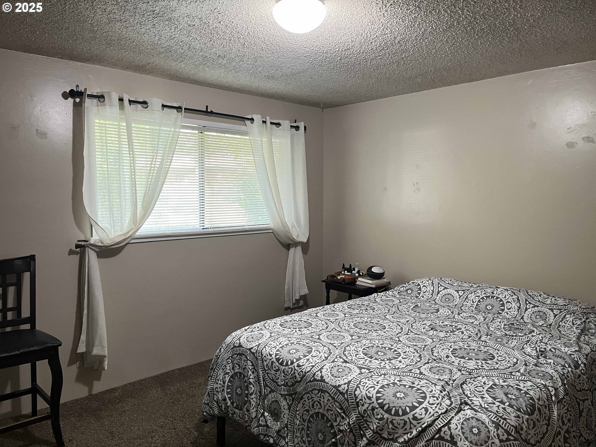 2215 24th Street Florence, OR 97439 - Photo 22 of 31 a bedroom with a bed and a window