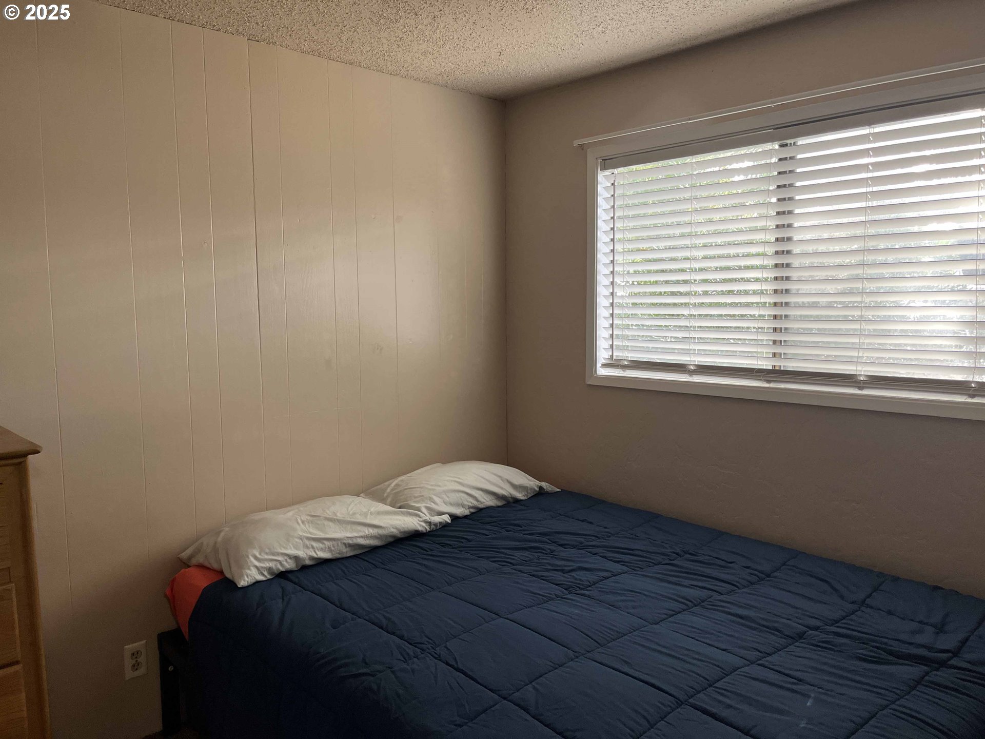 2215 24th Street Florence, OR 97439 - Photo 27 of 31 a bedroom with a bed and a window