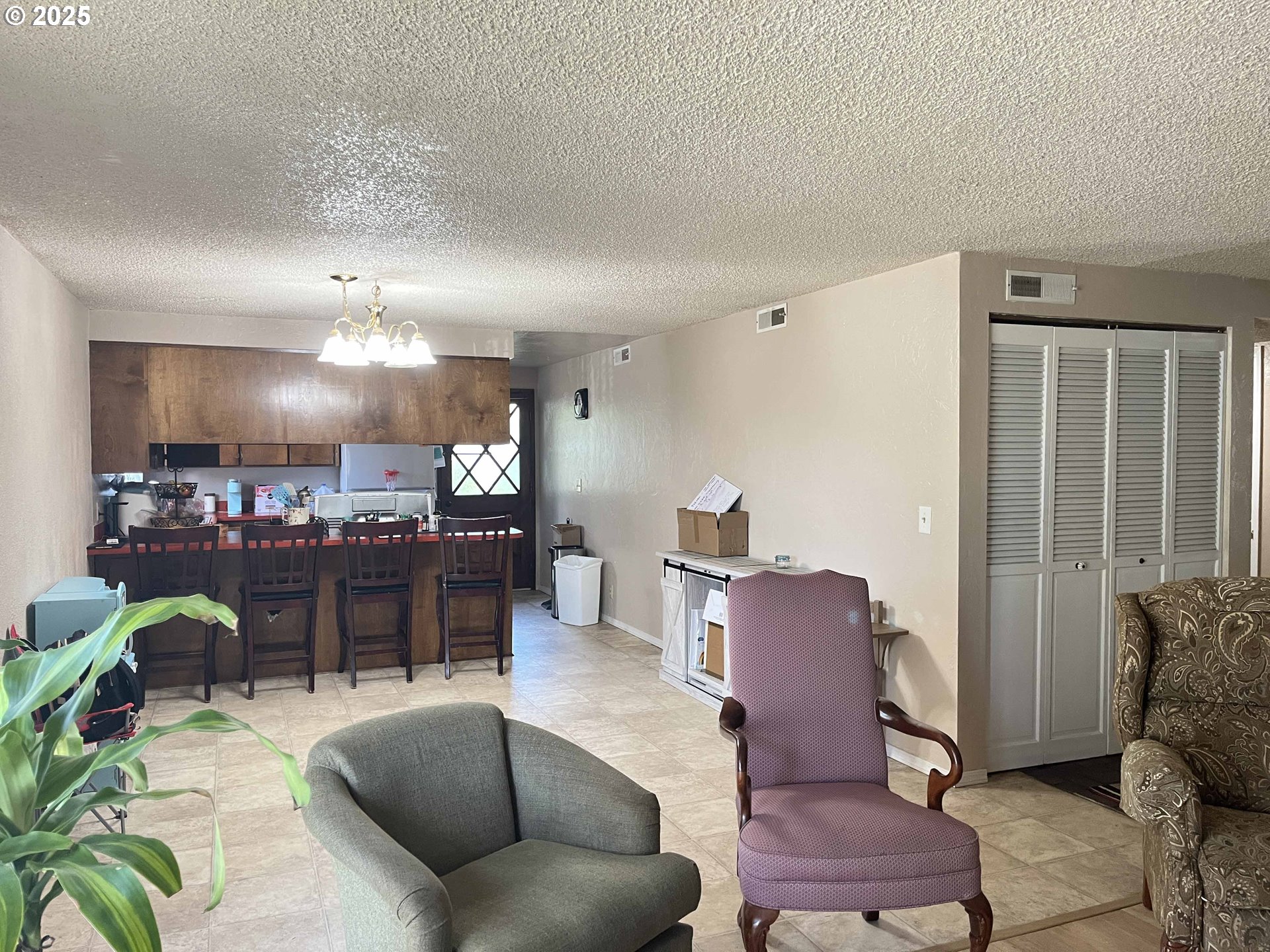 2215 24th Street Florence, OR 97439 - Photo 10 of 31 a living room with furniture a chandelier and a dining room