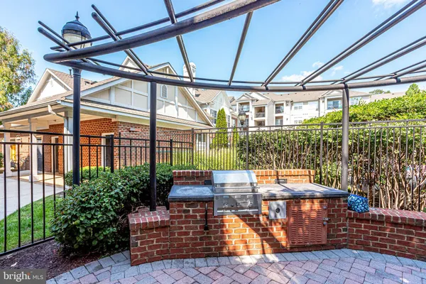 a view of a patio with table and chairs potted plants and large tree