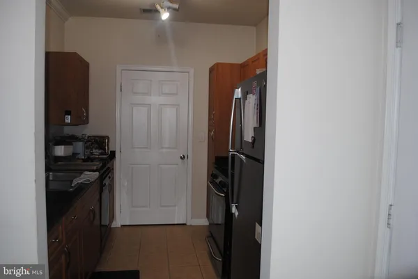a kitchen with stainless steel appliances a refrigerator and a stove top oven