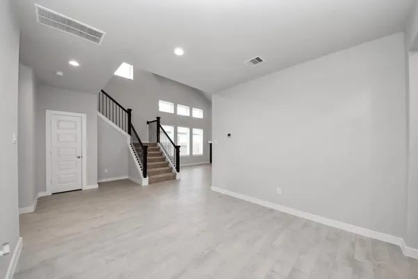 a large kitchen with kitchen island a stove a sink a center island and cabinets