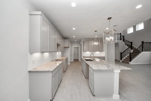 a kitchen with a stove a refrigerator and a sink