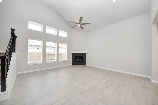 a view of an empty room with a fireplace and a window