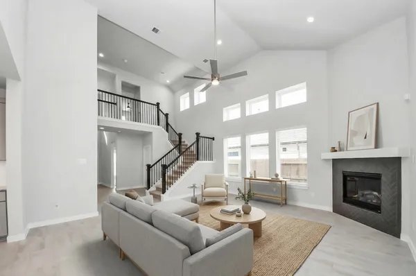 a view of staircase and kitchen with fireplace