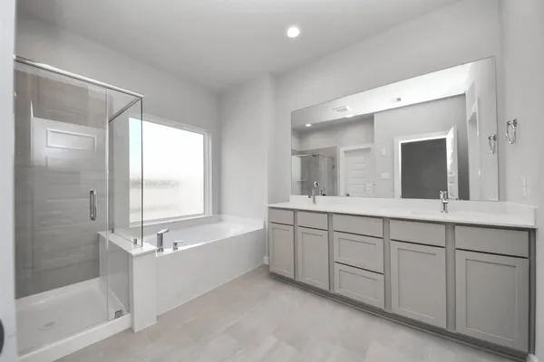 a bathroom with a bathtub and shower
