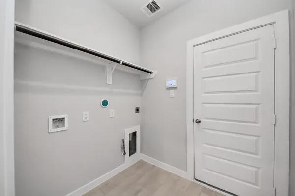 a view of a room with a wooden door and a yard