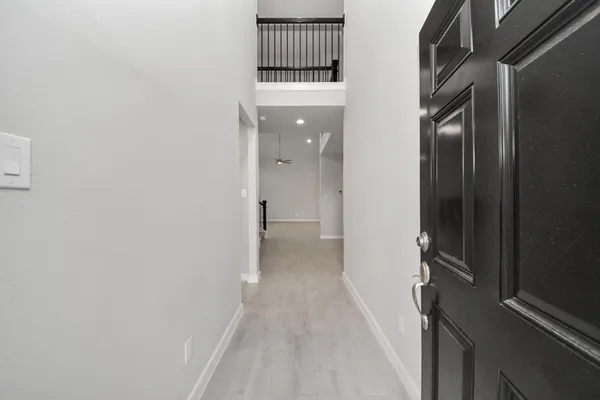 an empty room with closet and fan