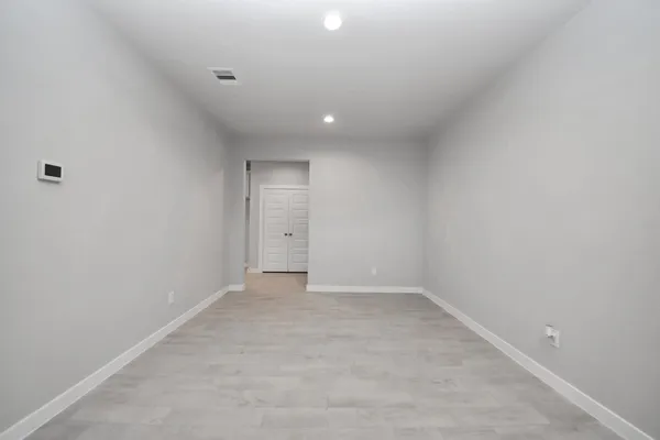an empty room with staircase and white walls