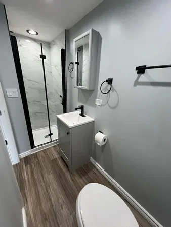 a bathroom with a toilet sink and mirror