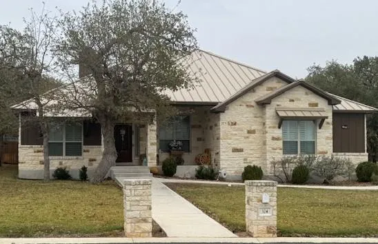 a view of a house with backyard porch and sitting area