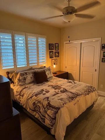 a bed sitting in a bedroom next to a window