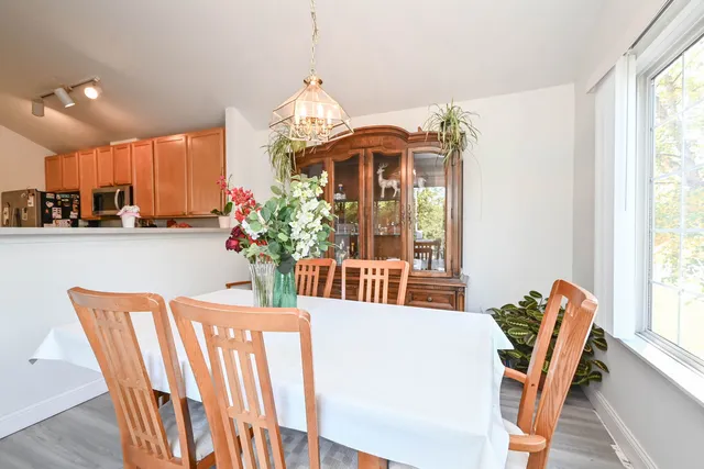 a dining room with furniture a livingroom and chandelier