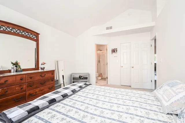 a bed room with a bed and a mirror