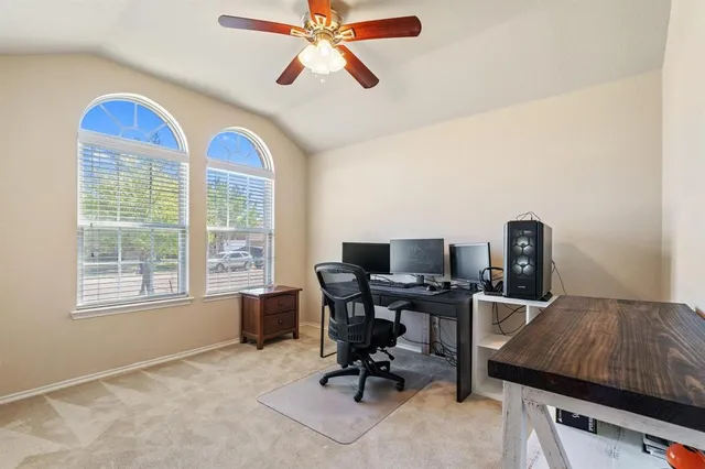 a view of a workspace with furniture and a window