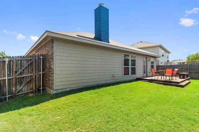 a view of a house with a yard and sitting area