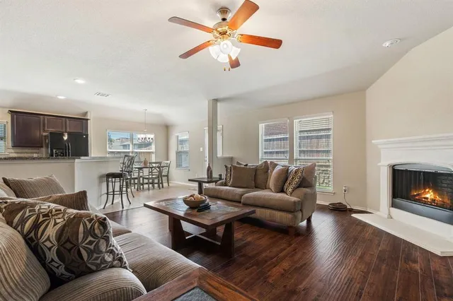 a living room with furniture flat screen tv and a fireplace