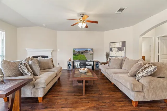 a living room with furniture and wooden floor
