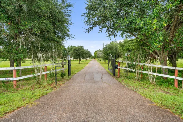 a living room with couches and kitchen view