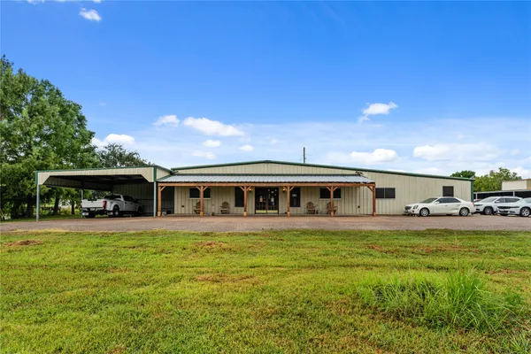 a living room with furniture a chandelier and a flat screen tv