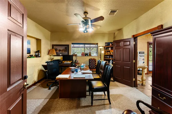 a living room with furniture cabinets and a flat screen tv