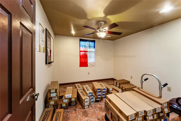 a living room with lots of furniture and clutter