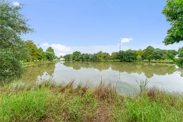 a view of a lake with houses in the back