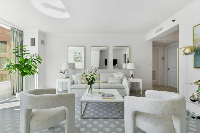 a living room with furniture and a potted plant