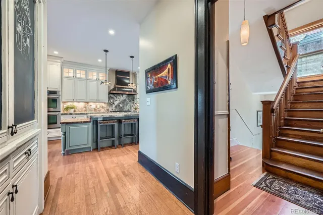 a view of kitchen with stainless steel appliances wooden floor and electronic appliances