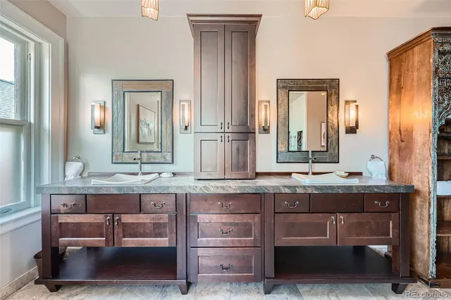 a bathroom with a granite countertop sink and a mirror