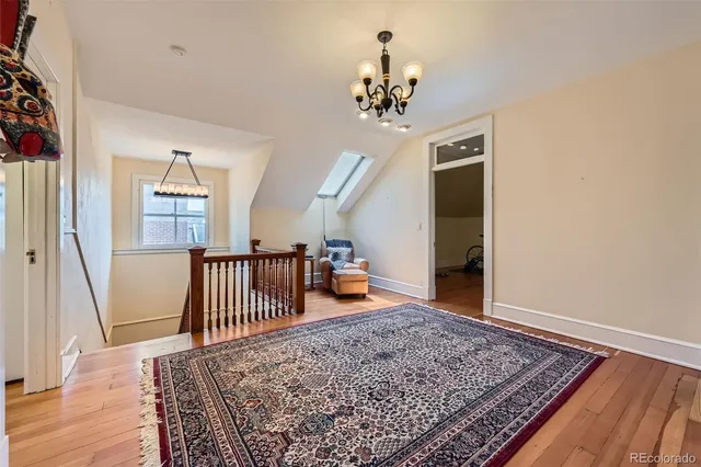 a bedroom with furniture and wooden floor