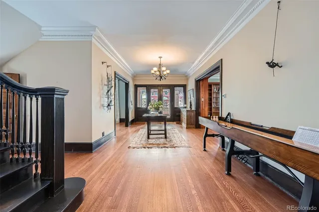 a view of a room with lots of wooden furniture and windows
