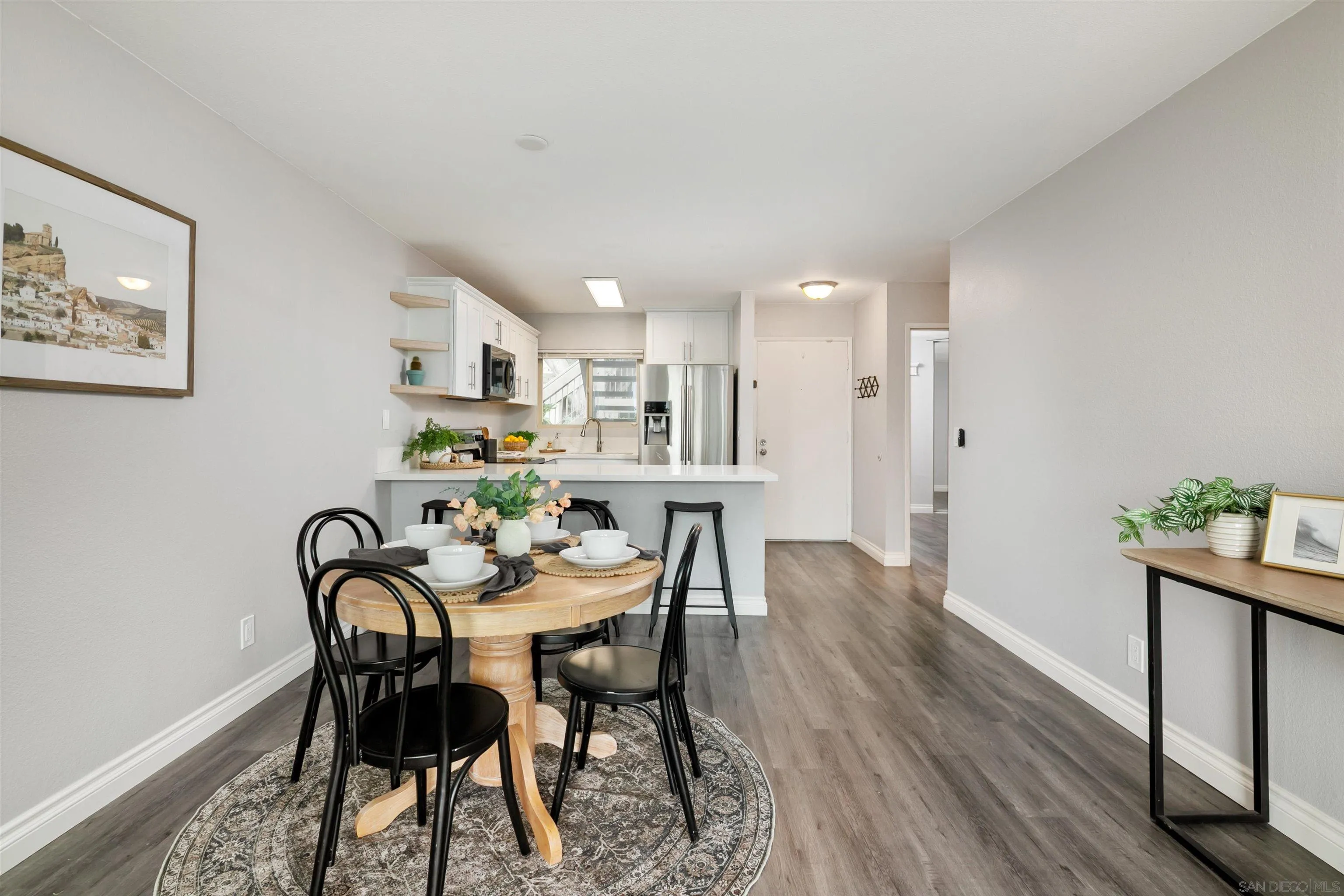 6675 Mission Gorge Road, Unit B104 San Diego, CA 92120 - Photo 3 of 14 a view of a dining room with furniture and wooden floor