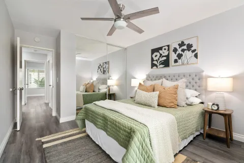 a bedroom with a large bed and a chandelier