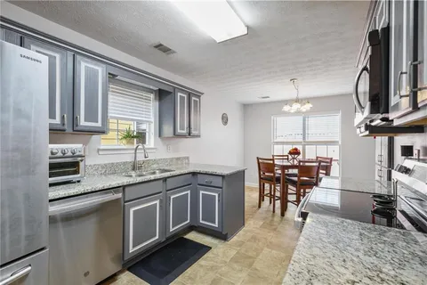 a kitchen with lots of counter top space and dining table