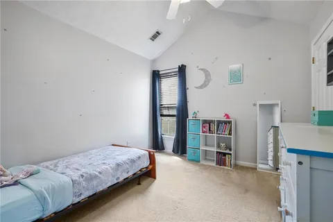 a bedroom with a bed and a book shelf