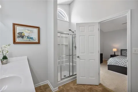 a bedroom with a bed and a bathroom
