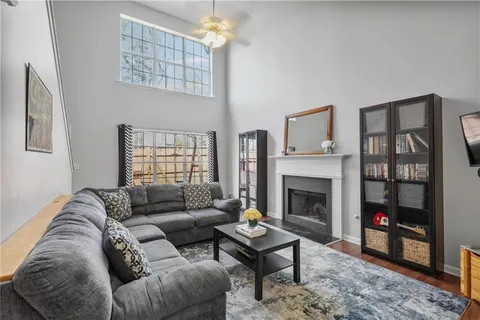 a living room with furniture a fireplace and a window