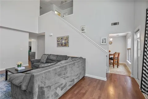 a living room with furniture and wooden floor