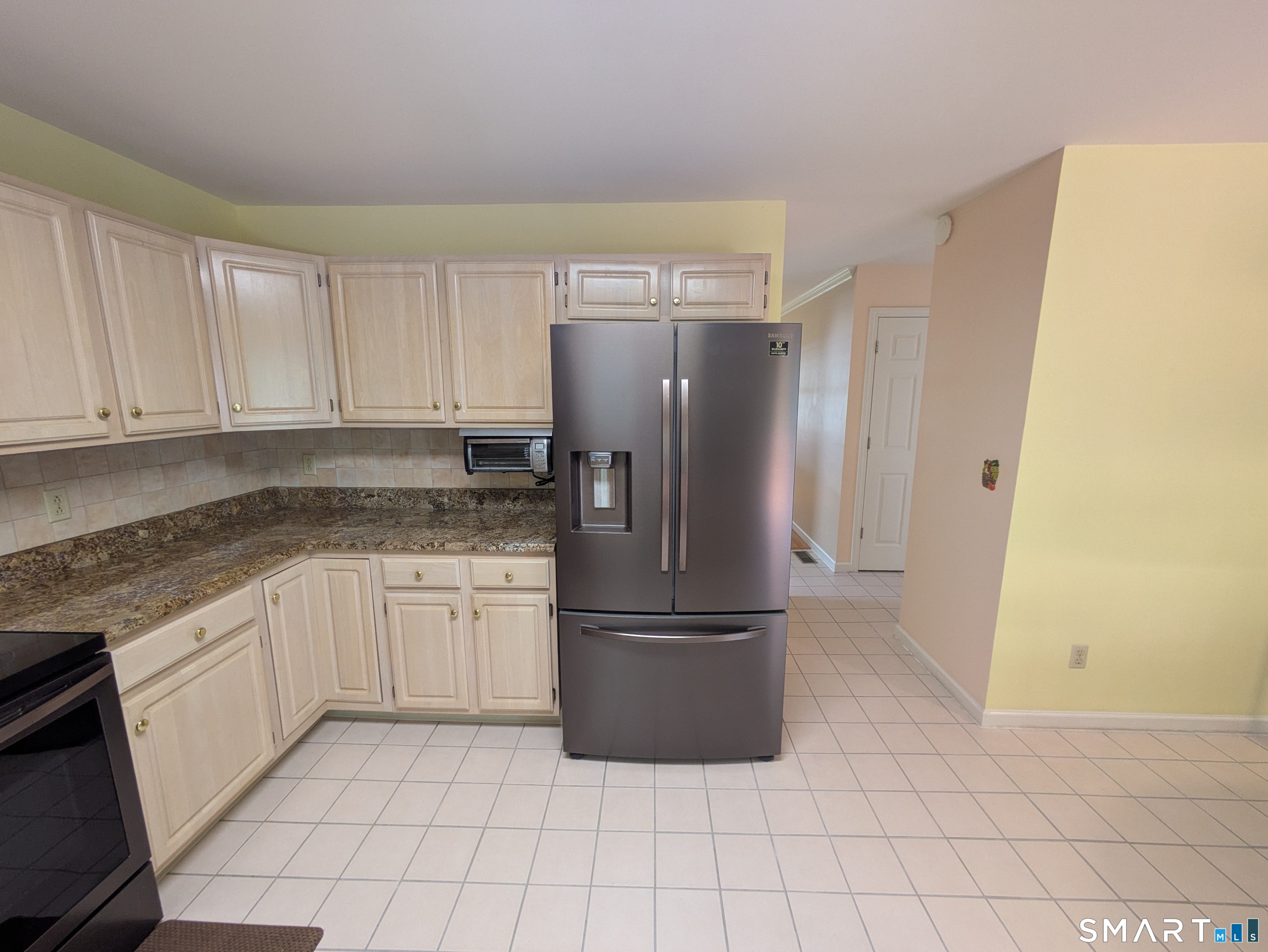 61 Basking Brook Road Shelton, CT 06484 - Photo 8 of 25 a kitchen with granite countertop a refrigerator and a sink