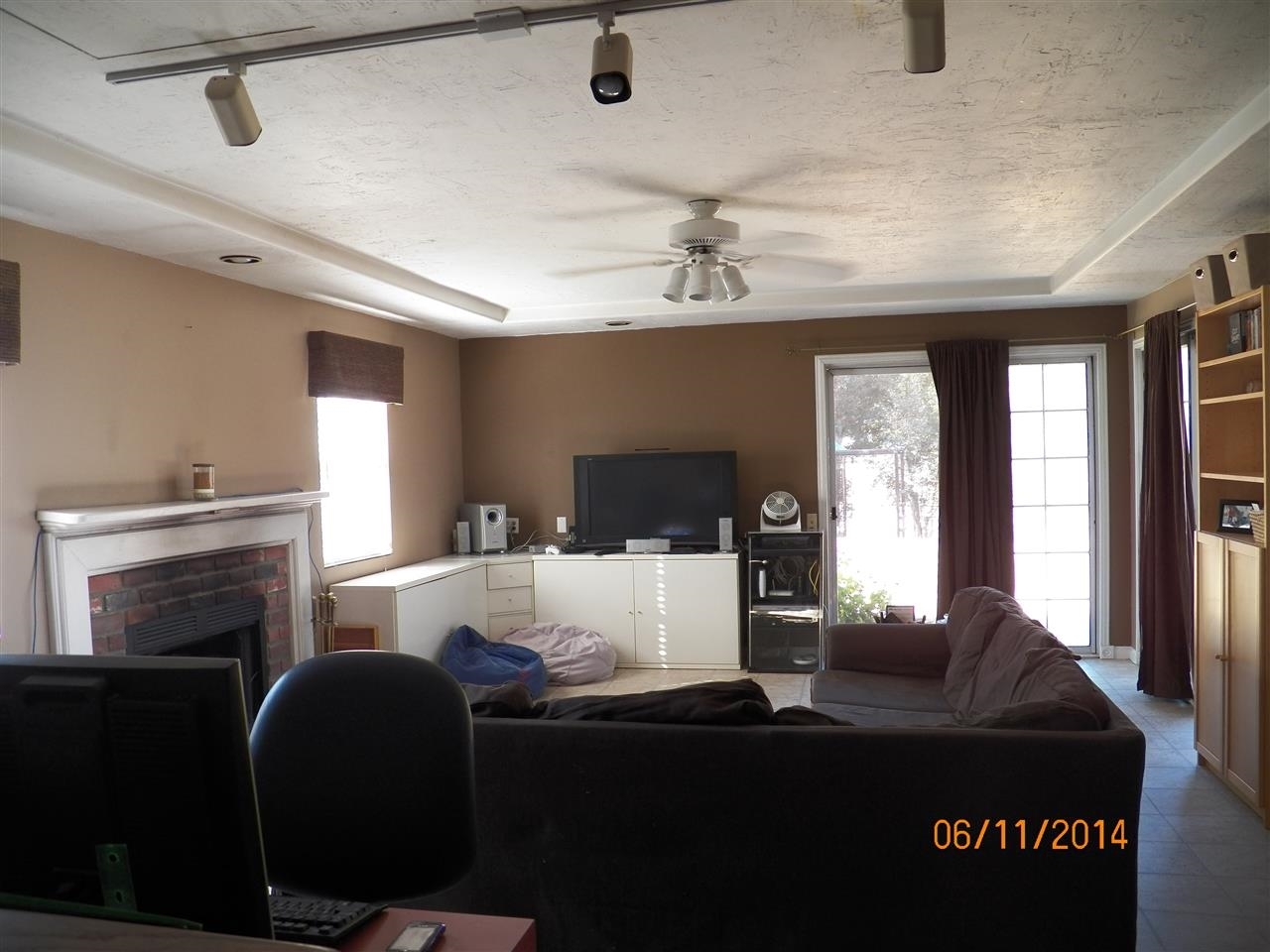 24952 Pappas Road Ramona, CA 92065 - Photo 7 of 21 Great Family Space, with 2nd fireplace, and two windows and two sliders bringing in light and leading to a relaxing patio with mountain views!
