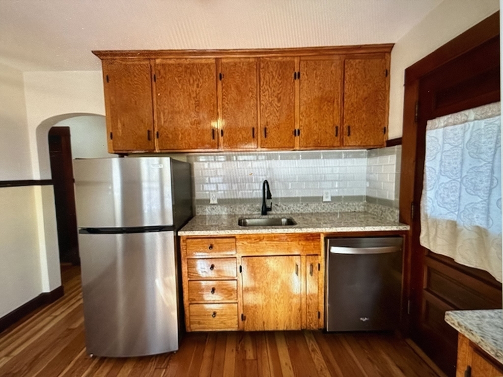 273-279 South Main Street Concord, NH 03301 - Photo 8 of 25 a kitchen with stainless steel appliances granite countertop a refrigerator a sink and a stove