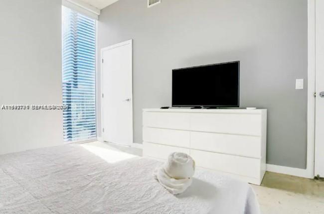 151 Southeast 1st Street, Unit 3111 Miami, FL 33131 - Photo 12 of 35 a living room with furniture and a flat screen tv