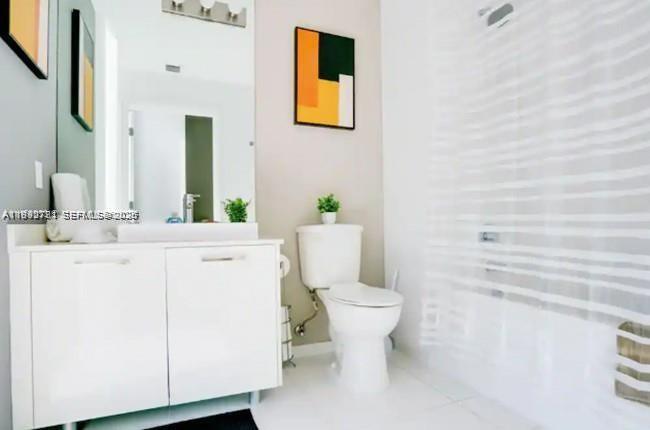 151 Southeast 1st Street, Unit 3111 Miami, FL 33131 - Photo 14 of 35 a bathroom with a sink a toilet and mirror