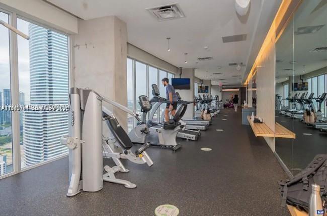 151 Southeast 1st Street, Unit 3111 Miami, FL 33131 - Photo 24 of 35 a view of a room with gym equipment