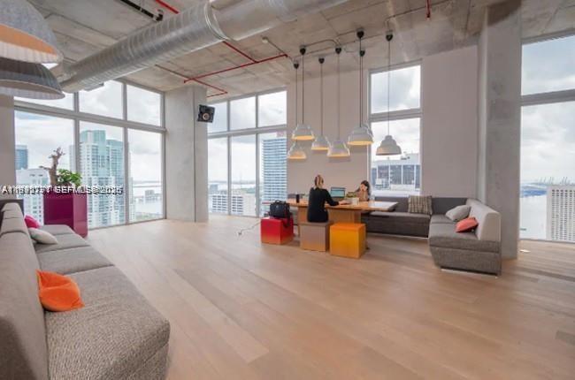 151 Southeast 1st Street, Unit 3111 Miami, FL 33131 - Photo 29 of 35 a living room filled with furniture and floor to ceiling windows