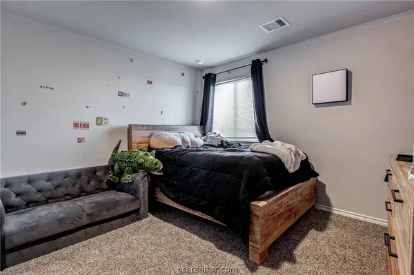 a bedroom with furniture and a window