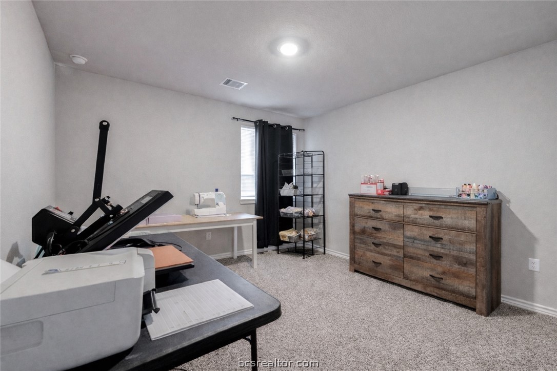 2176 Chief Street Bryan, TX 77807 - Photo 13 of 21 a bedroom with a bed and a desk