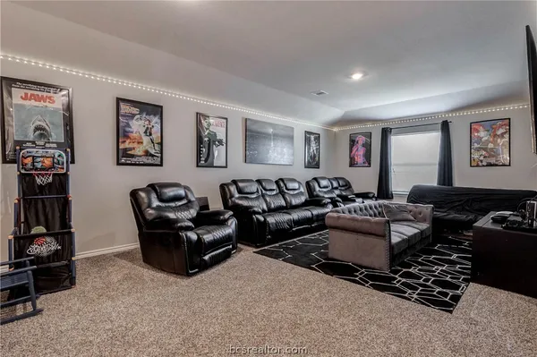 a living room with furniture a couch and dresser
