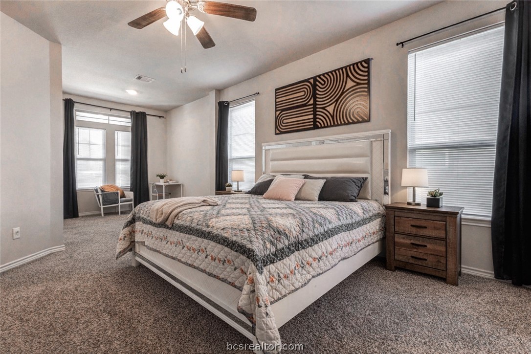 2176 Chief Street Bryan, TX 77807 - Photo 15 of 21 a bedroom with a large bed and a chandelier